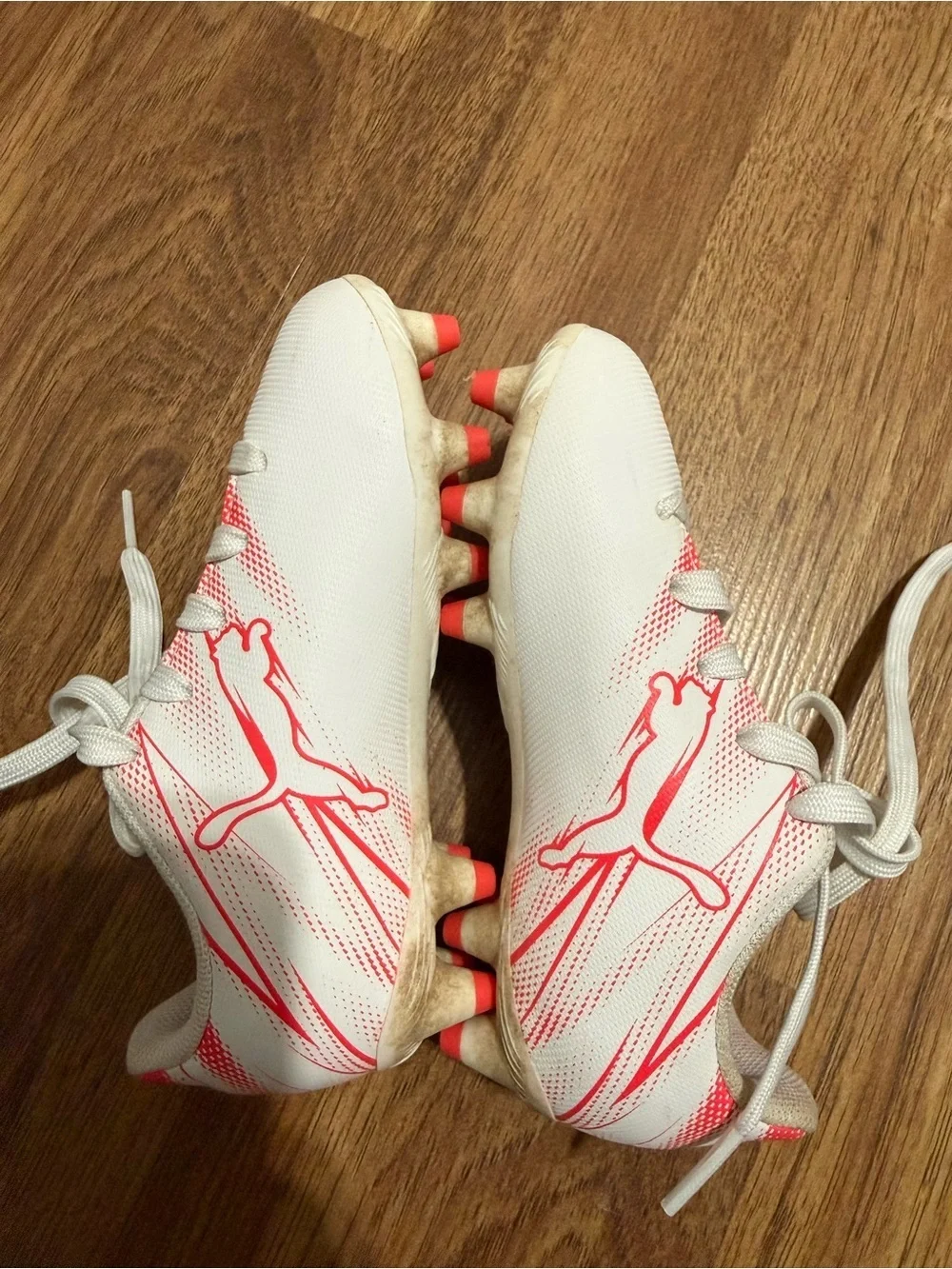 Puma cleats in Bright Pink and white